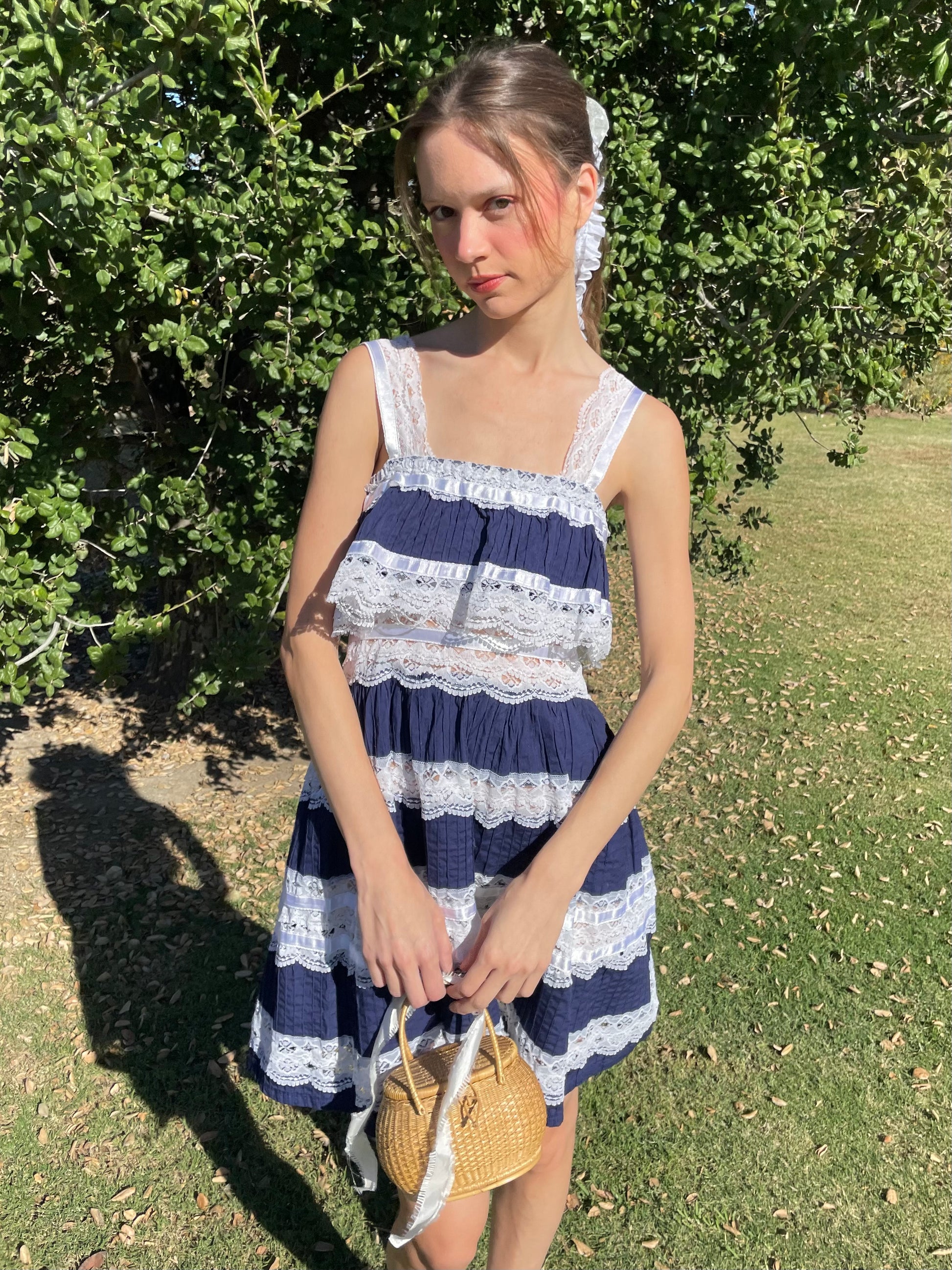 girl in blue and white lace dress