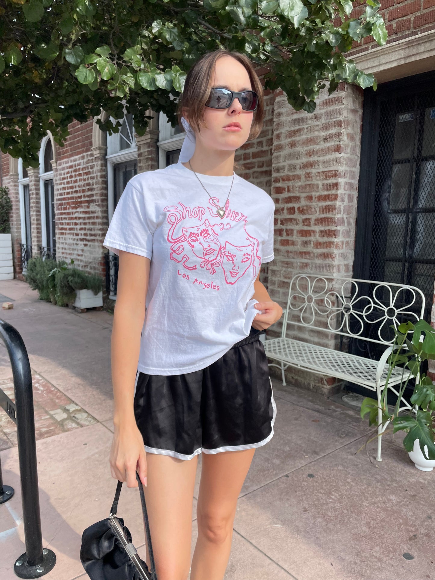 girl in graphic t-shirt and black shorts