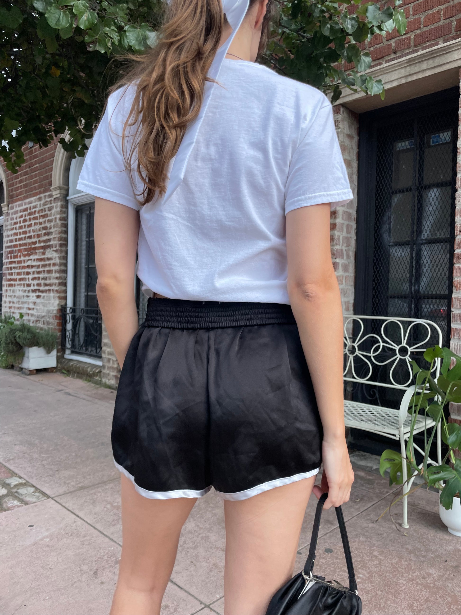 girl in graphic t-shirt and black shorts