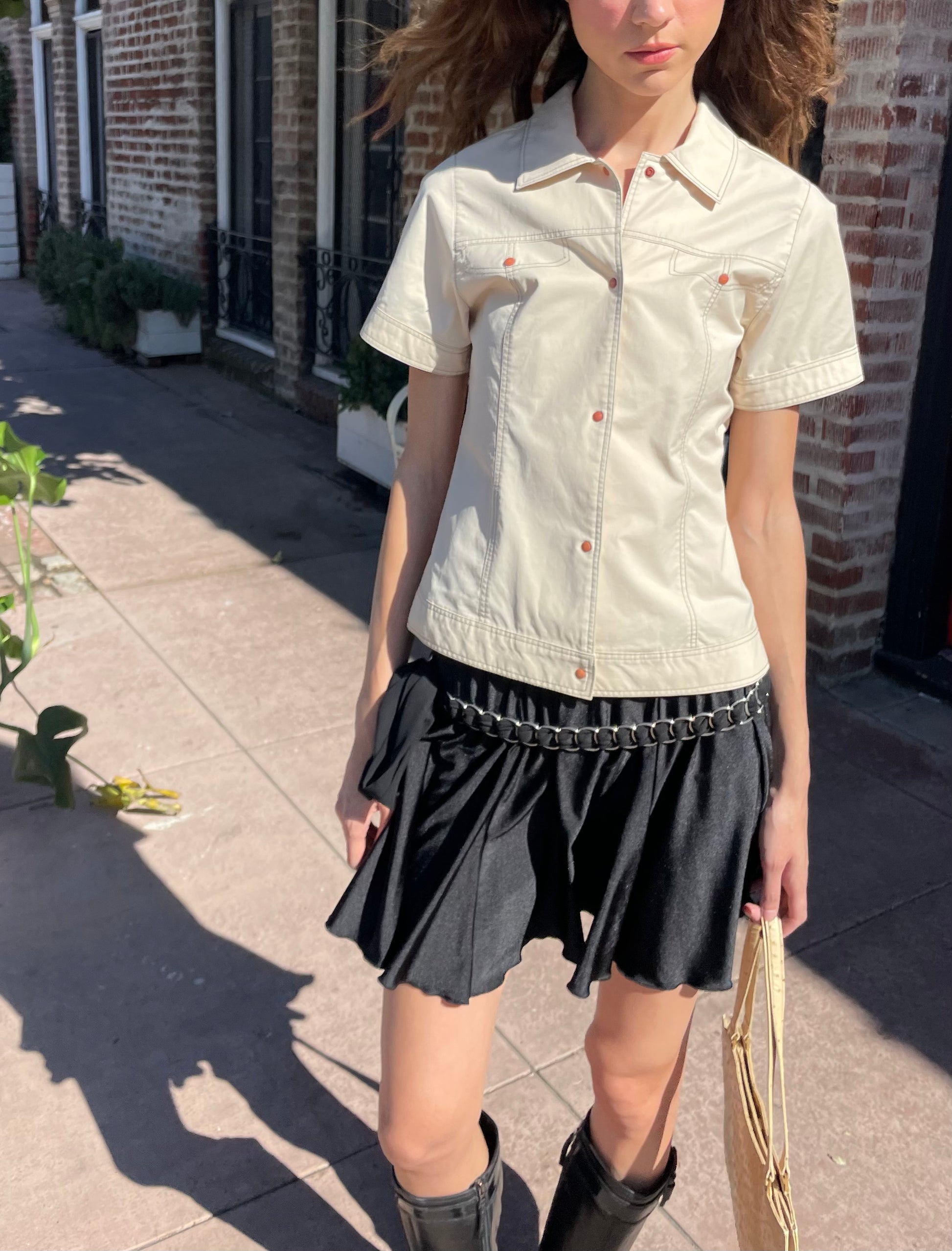 girl in yellow button up and black skirt