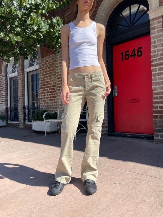 girl in white tank top and tan cargo pants