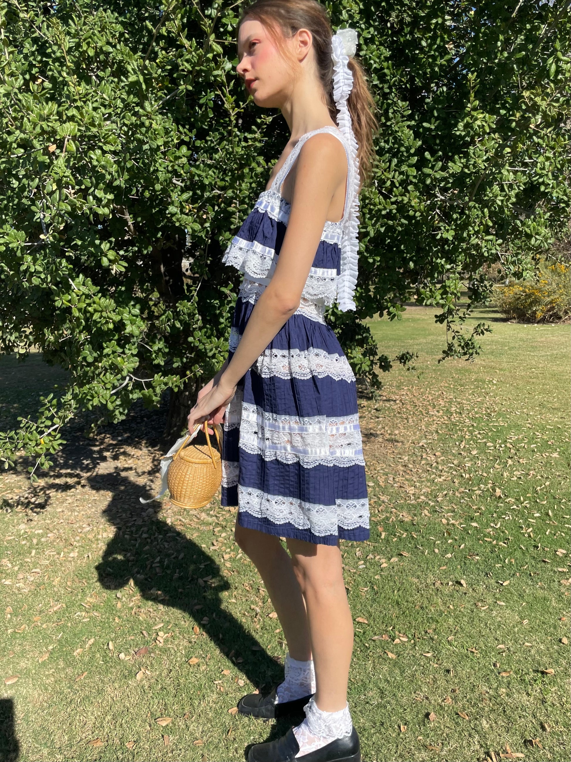 girl in blue and white lace dress