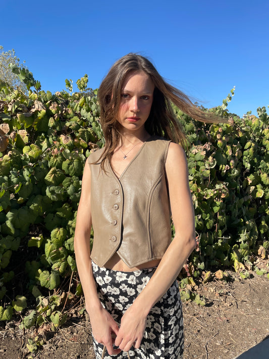 girl in brown leather vest