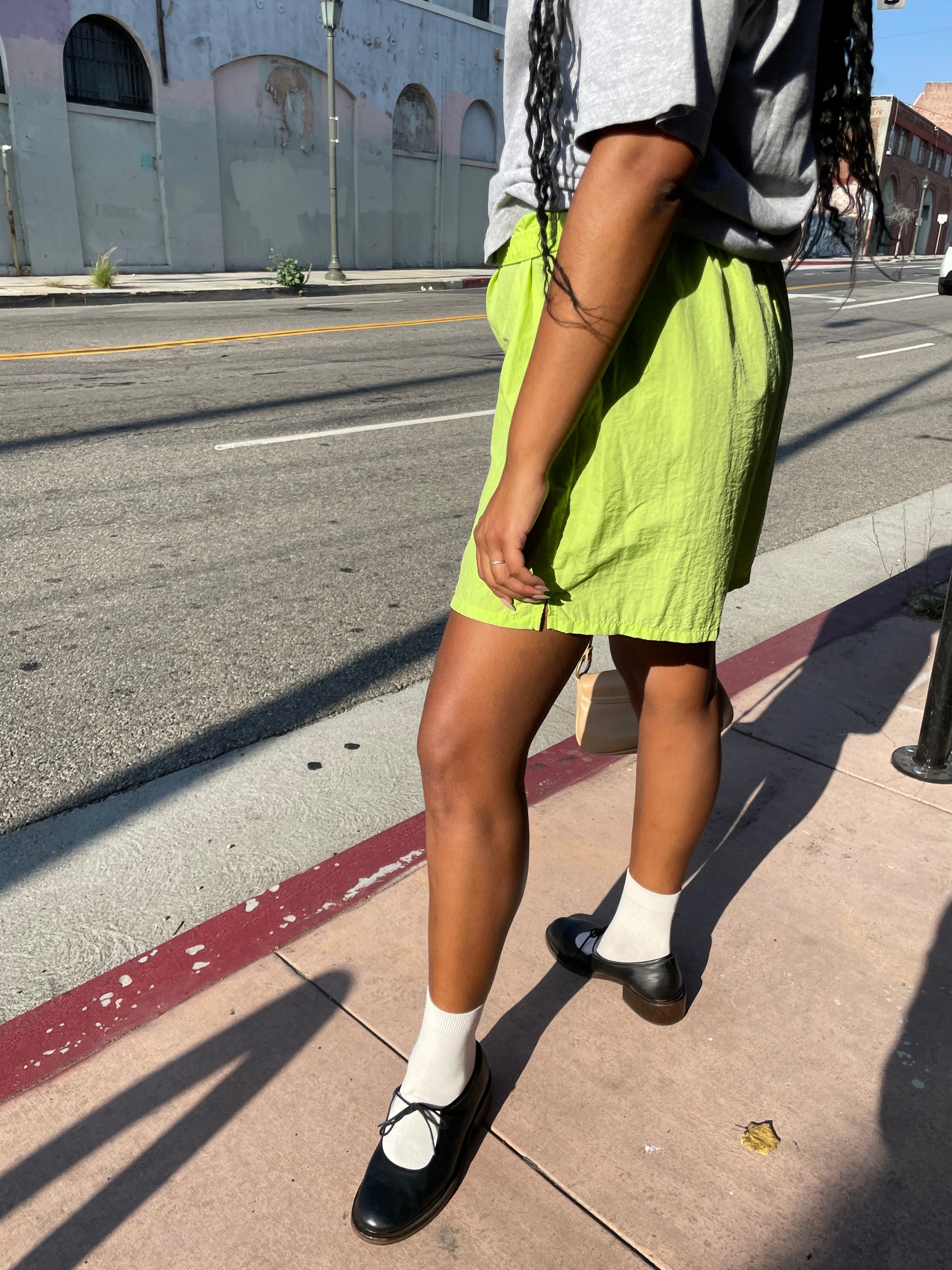 Girl wearing lime green runner shorts