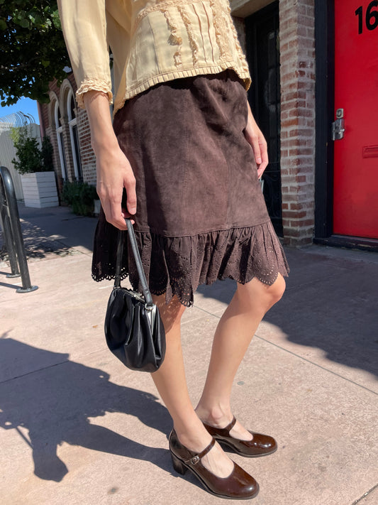 girl in yellow top and brown knee skirt