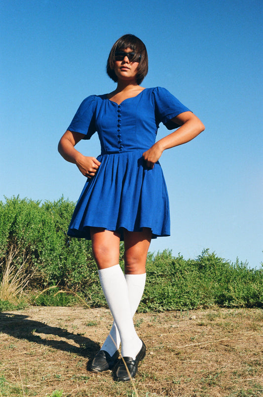 girl wearing blue dress and tall white socks