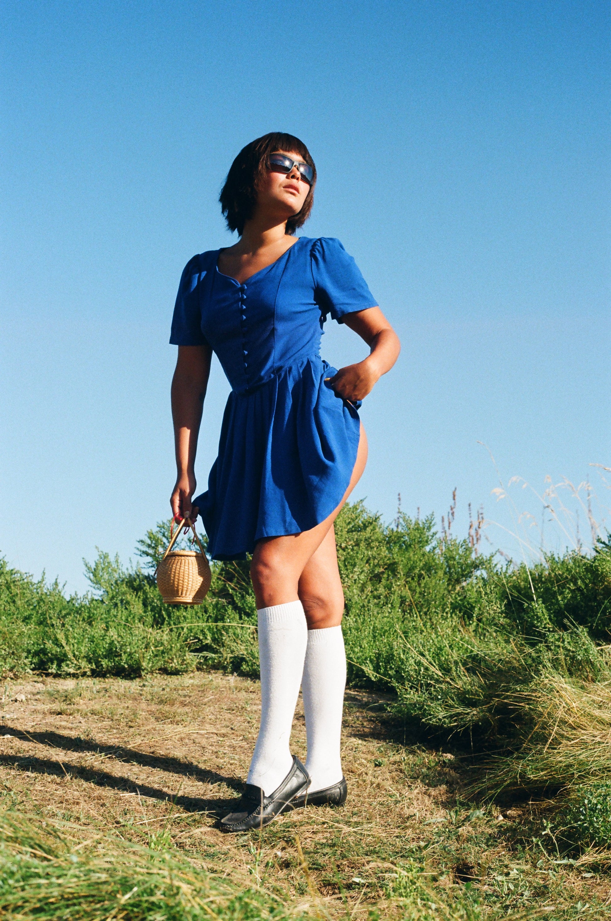 girl wearing blue dress and tall white socks