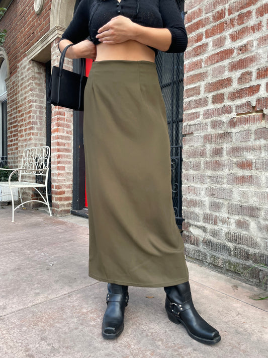 model wearing long green skirt and black cardigan