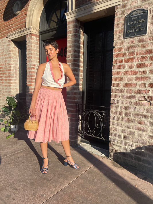 girl in cream halter and pink skirt