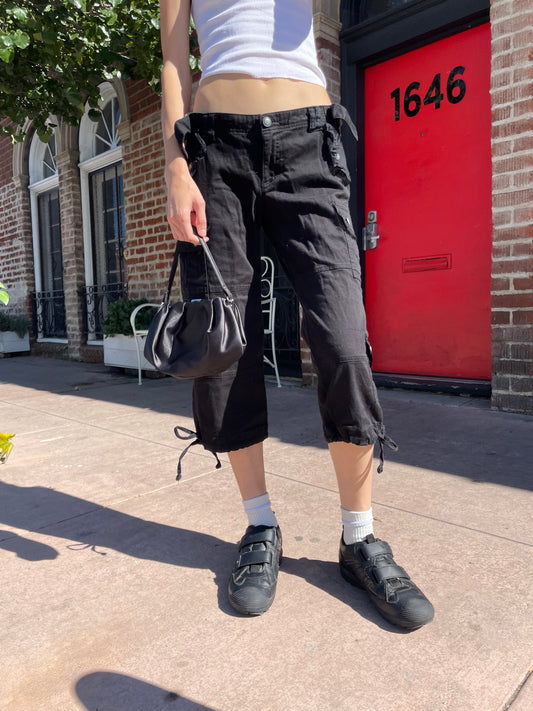 girl in white tank top and black cargo capris