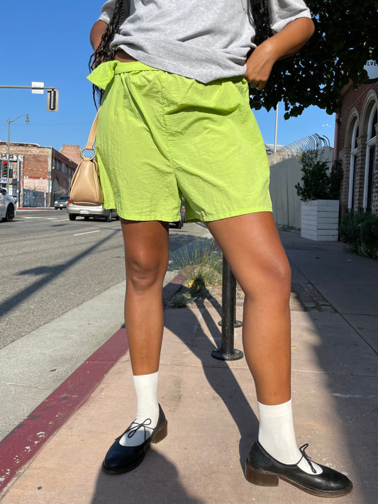 Girl wearing lime green runner shorts