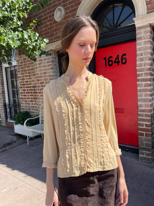 girl in yellow button up and brown skirt