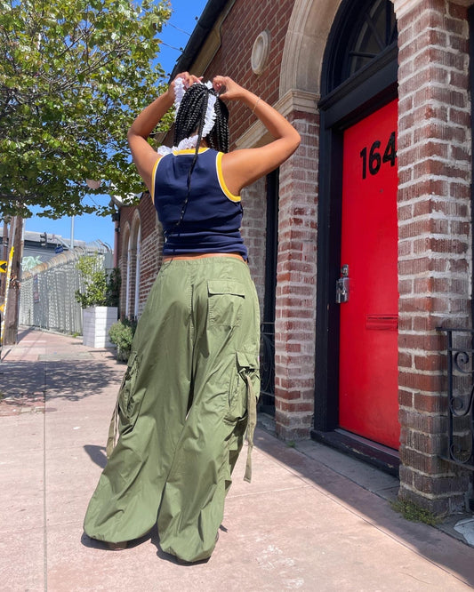 girl wearing blue tank top and baggy green cargo pants