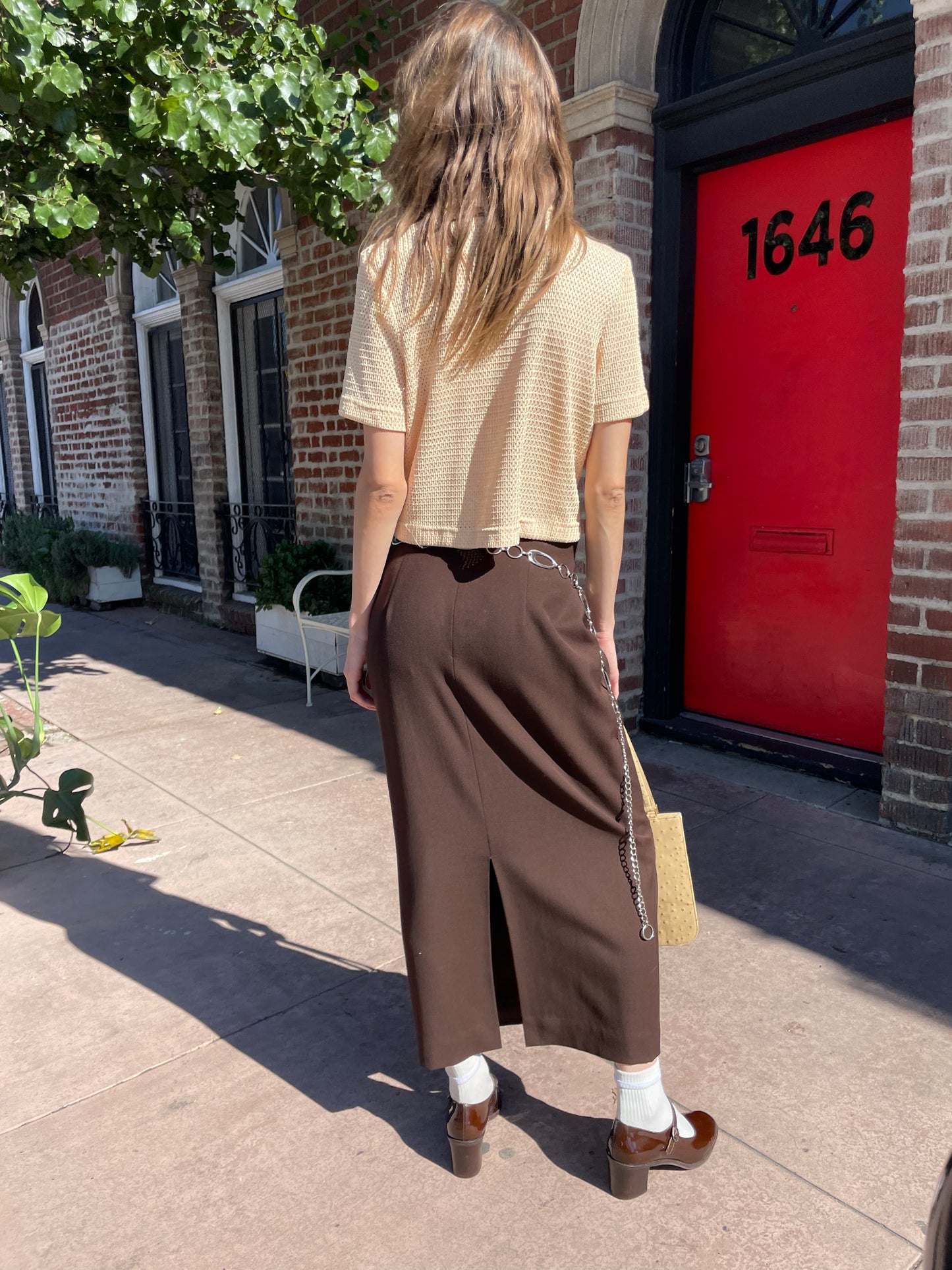 girl in yellow top and brown skirt