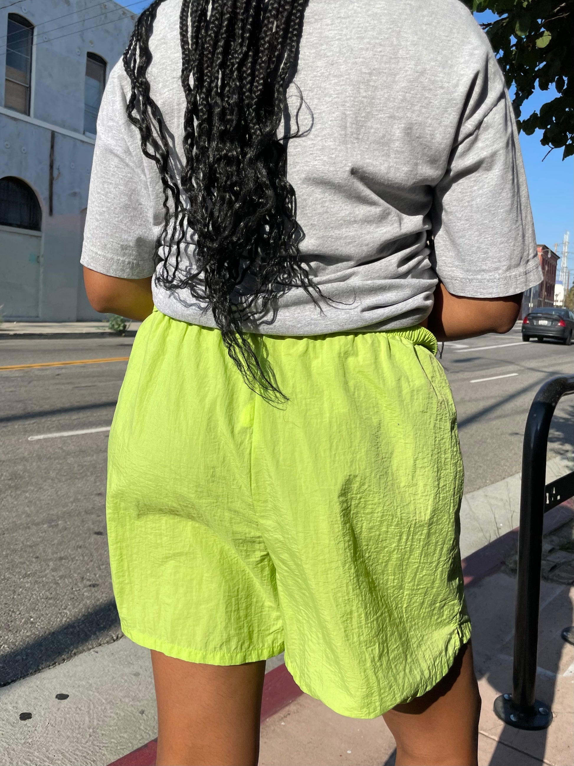 Girl wearing lime green runner shorts