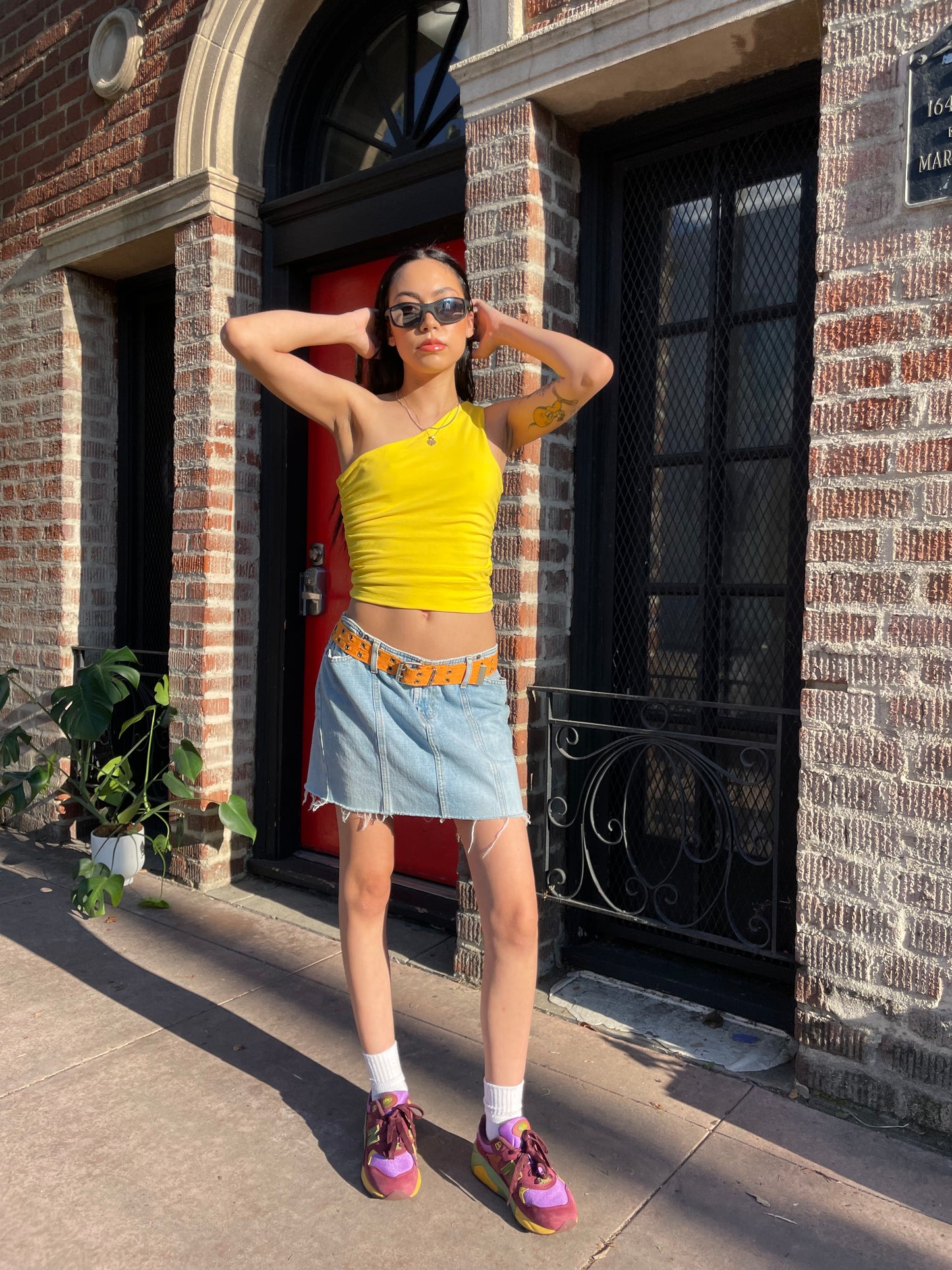 girl in yellow top and denim skirt