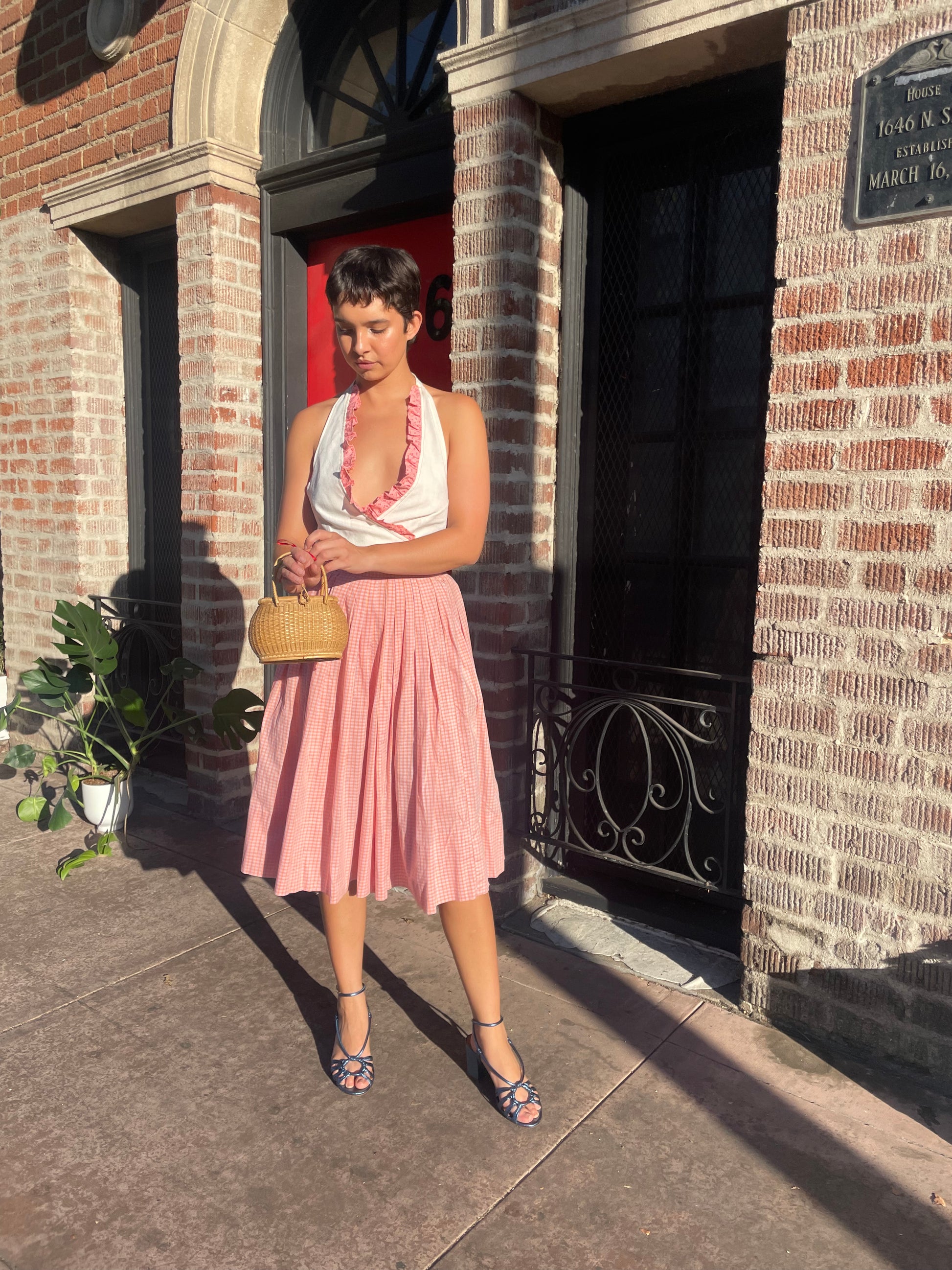 girl in cream halter and pink skirt