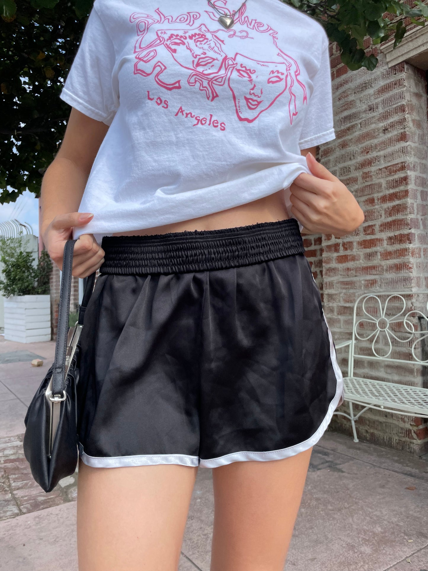 girl in graphic t-shirt and black shorts