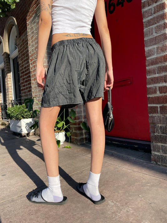 girl in white tank and boxer shorts