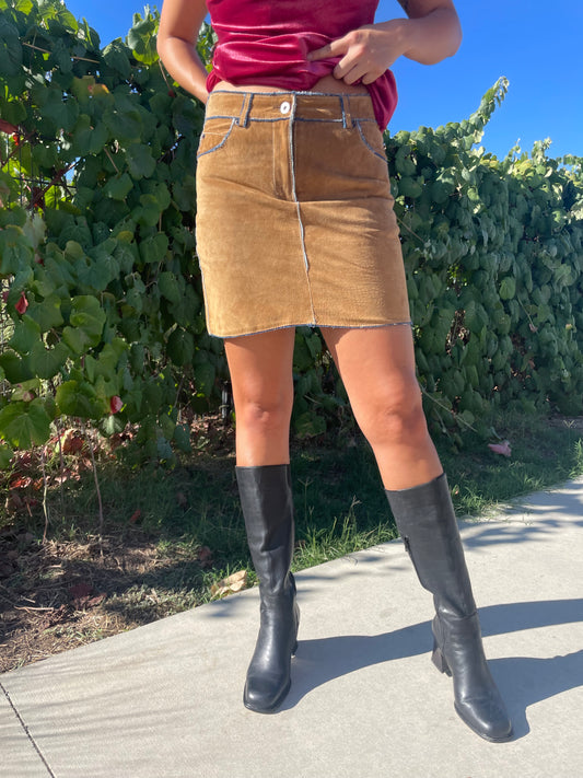 girl wearing suede mini skirt and black boots