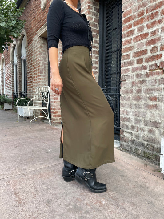 model wearing long green skirt and black cardigan