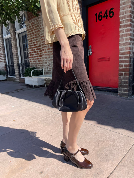 girl in yellow top and brown knee skirt