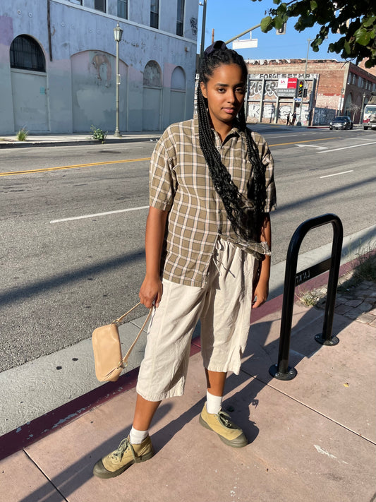 girl in plaid green button up and khaki pants