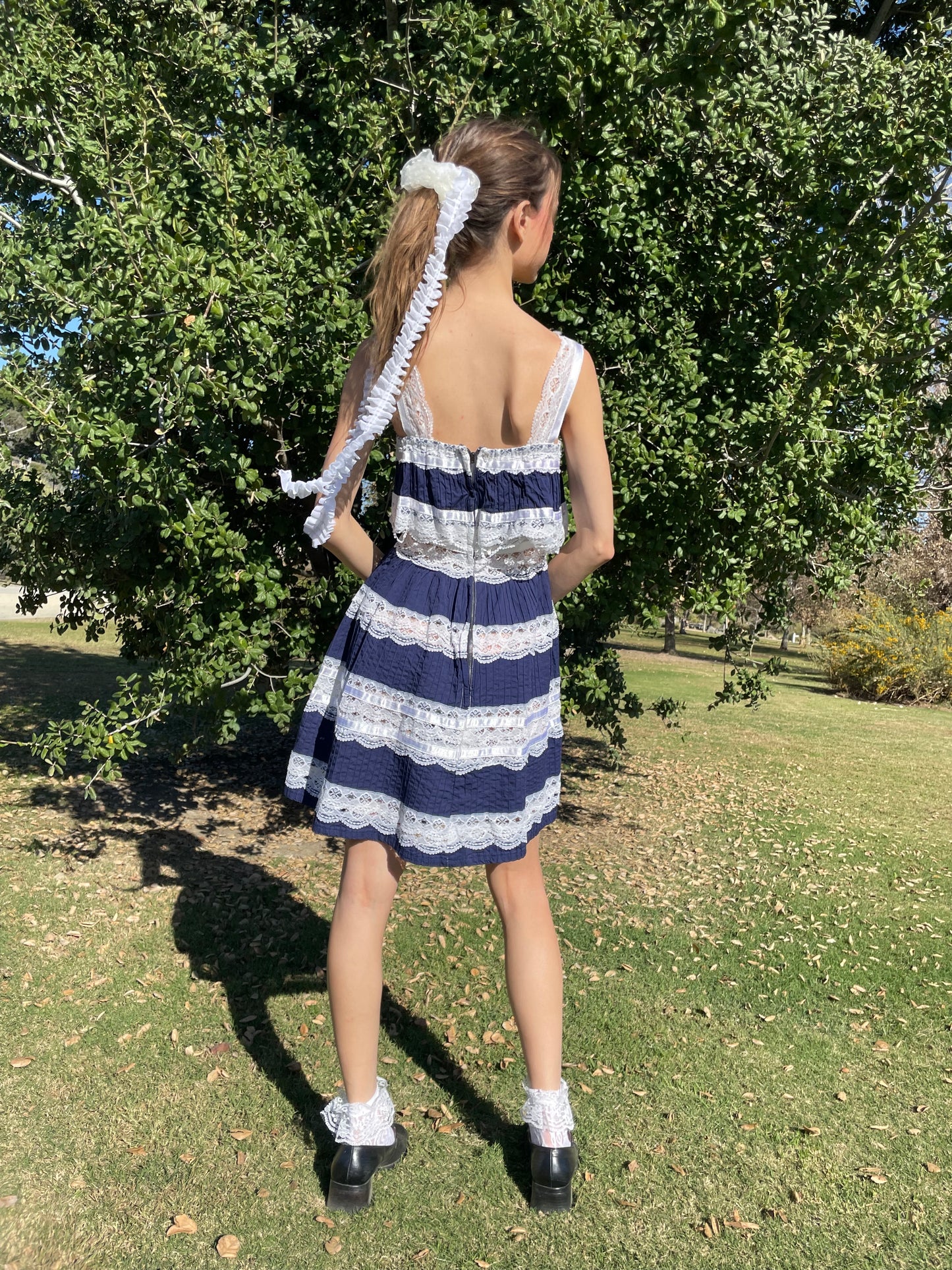 girl in blue and white lace dress