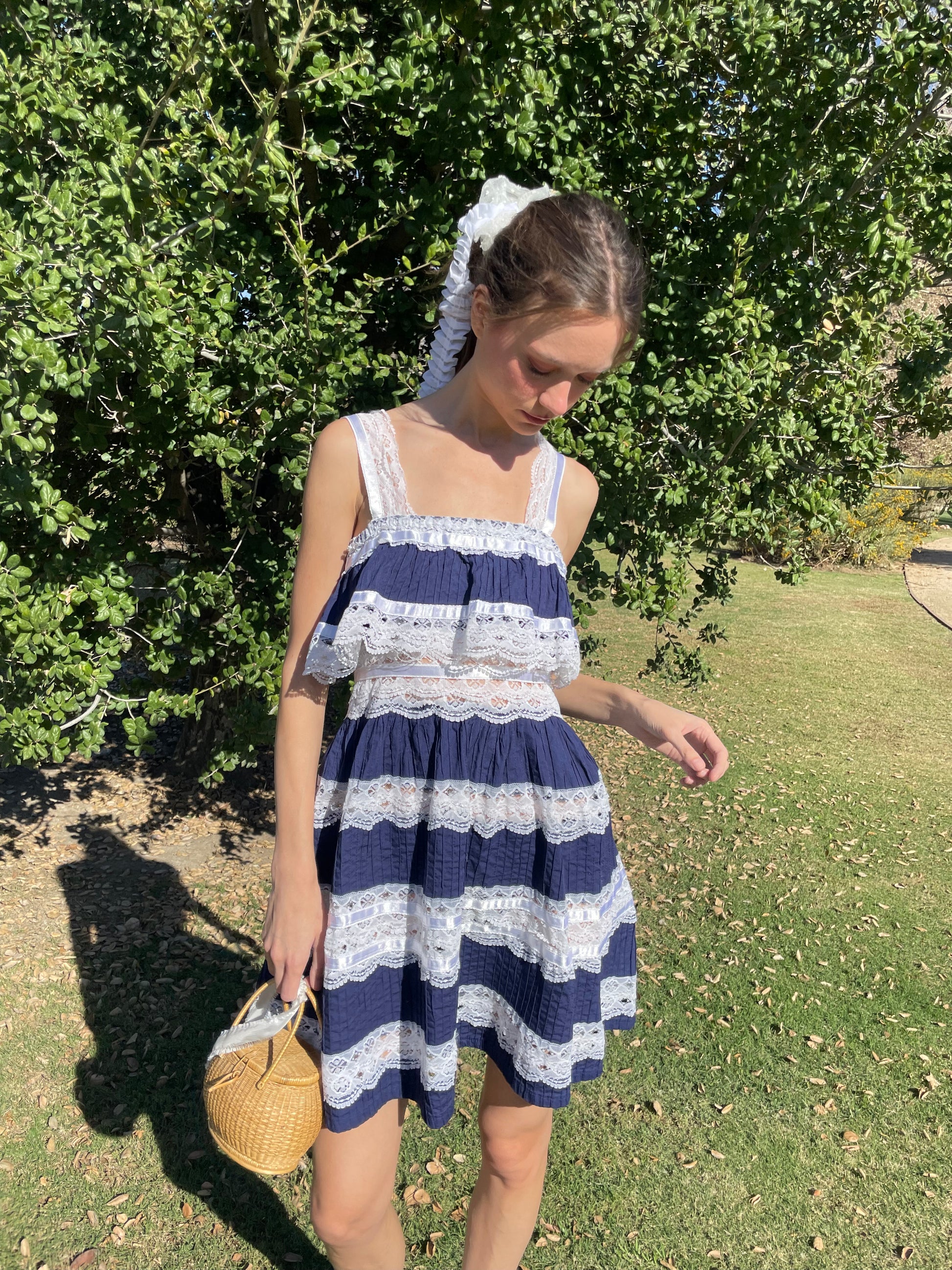 girl in blue and white lace dress