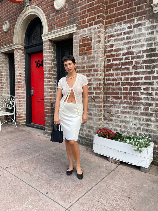 girl in white top and sheer white skirt