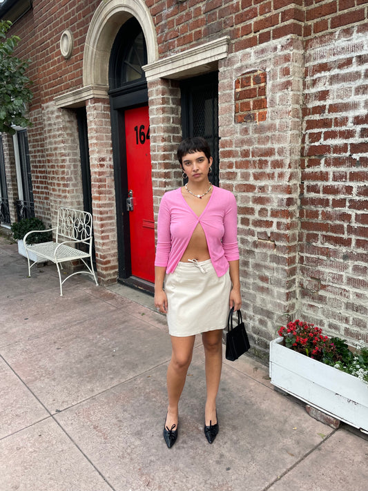 girl in pink top and cream skirt