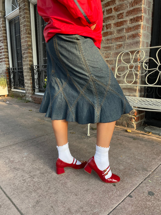 girl in red jacket and denim skirt