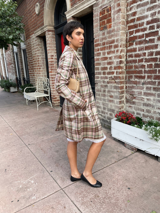 girl wearing plaid trench coat