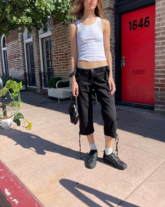 girl in white tank top and black cargo capris