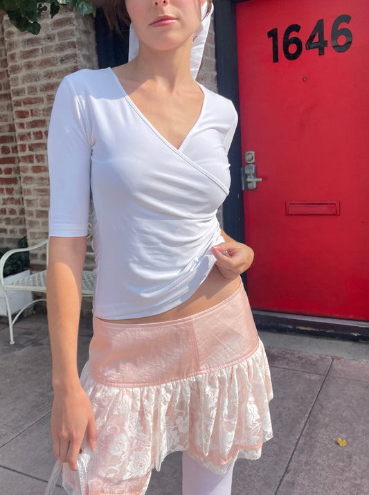 girl in white top and pink skirt