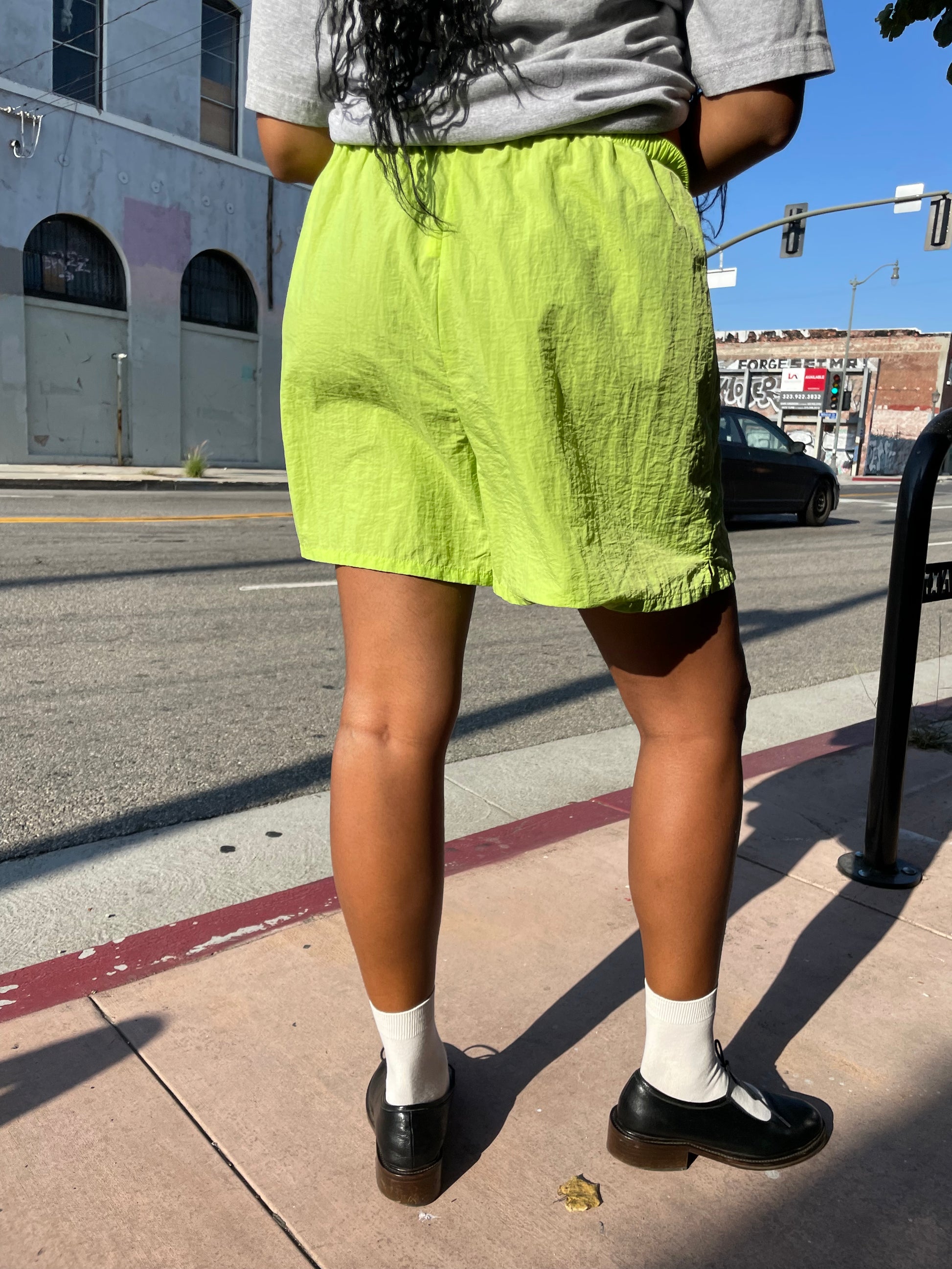 Girl wearing lime green runner shorts