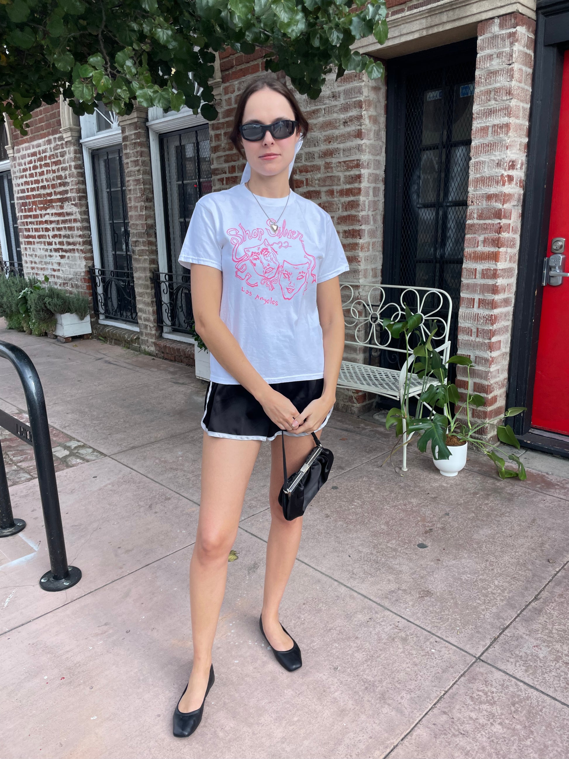 girl in graphic t-shirt and black shorts