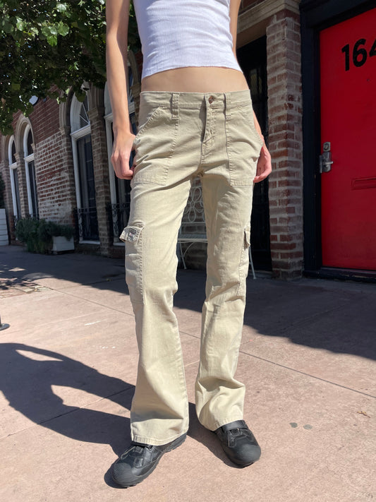 girl in white tank top and tan cargo pants