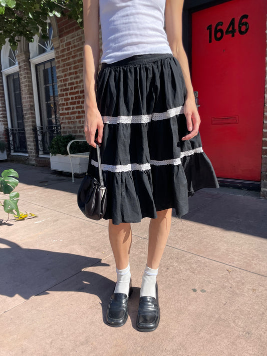 girl in white tank top and black skirt