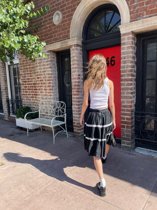 girl in white tank top and black skirt