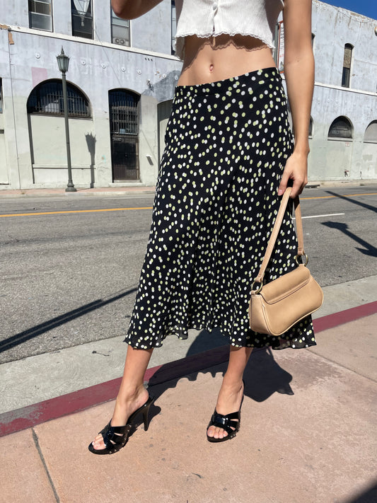 girl in black polka dot dress