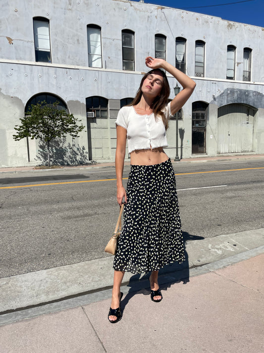 girl in black polka dot dress