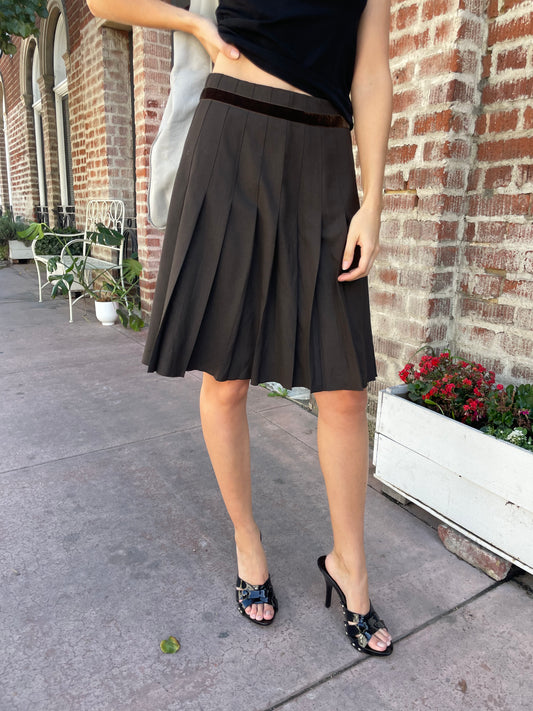 girl in brown pleated skirt 