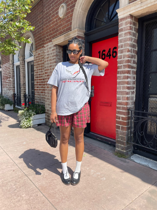 girl wearing vintage corvette shirt and red plaid skirt