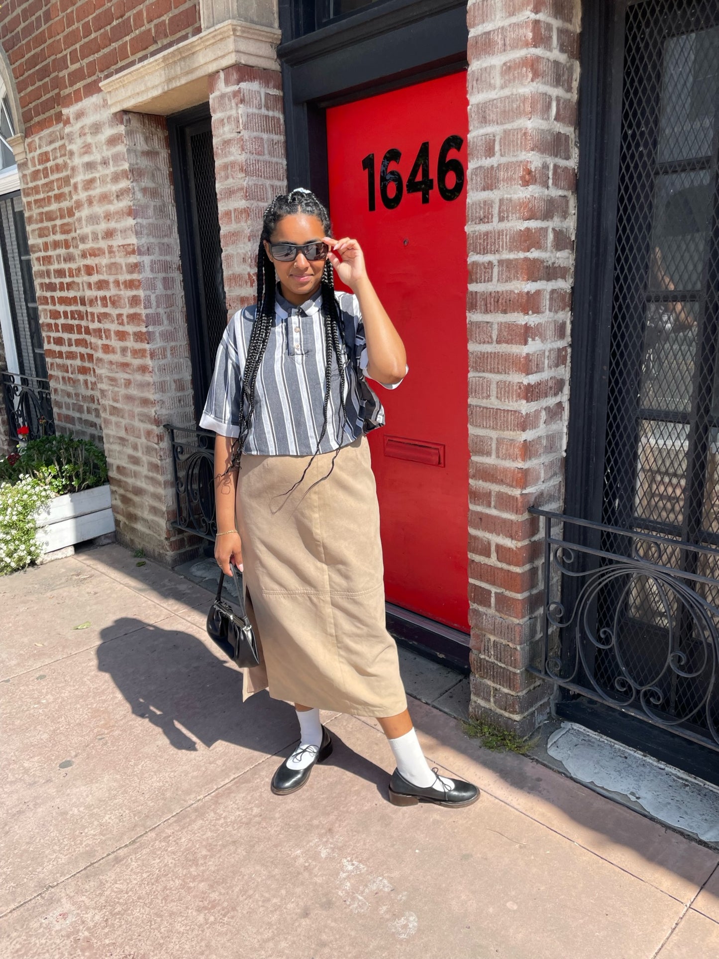 girl wearing black and white striped shirt and long tan skirt