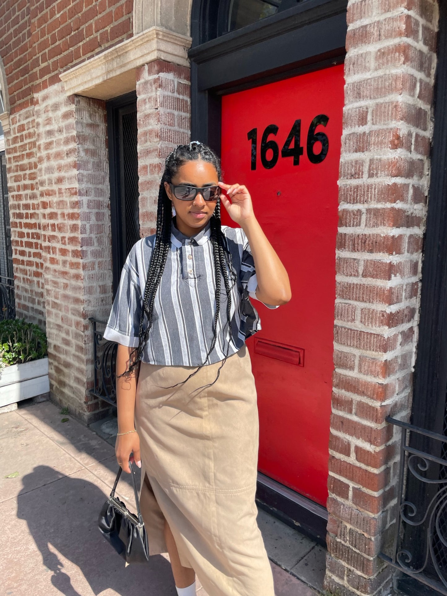 girl wearing black and white striped shirt and long tan skirt