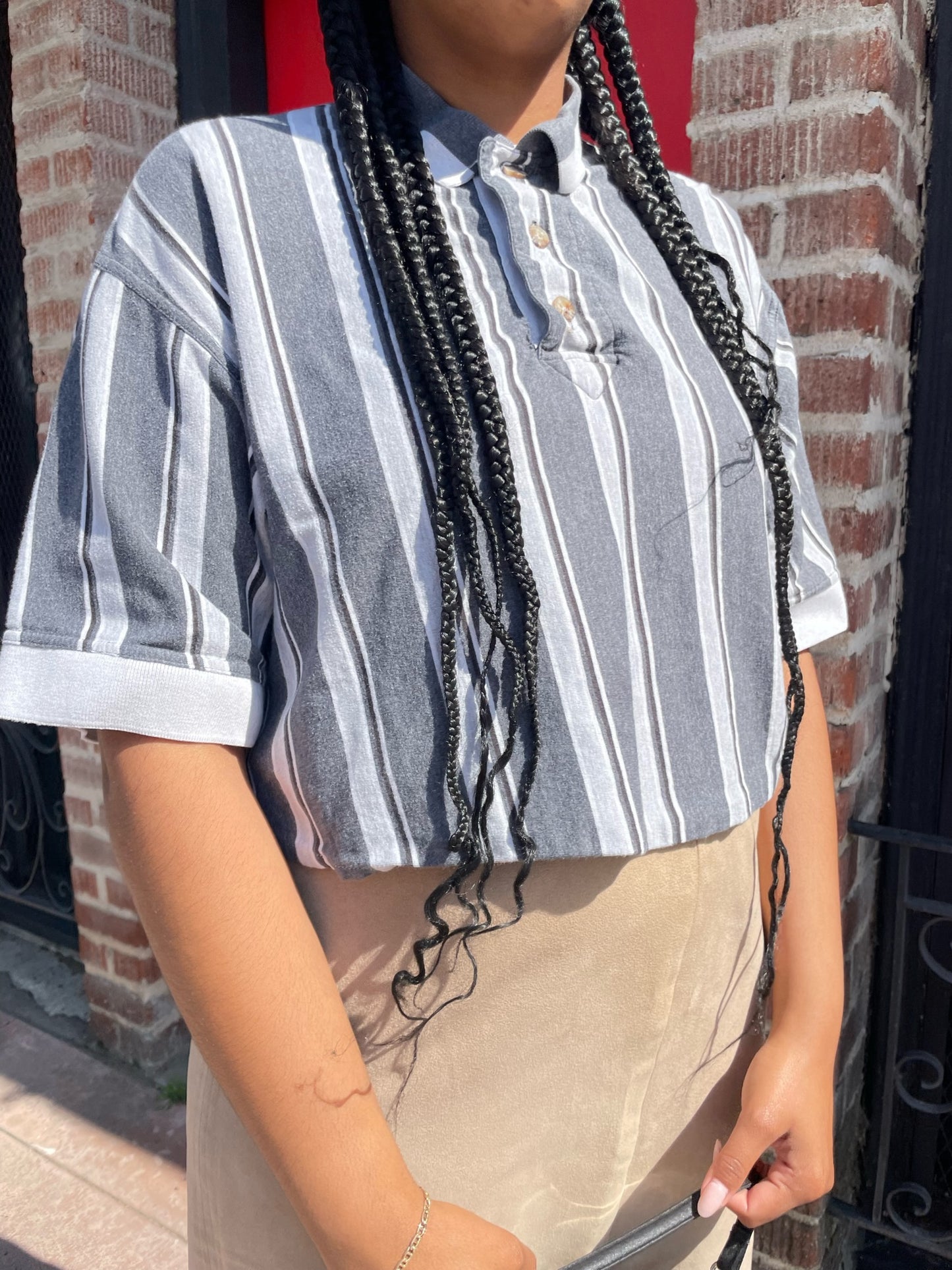 girl wearing black and white striped shirt and long tan skirt