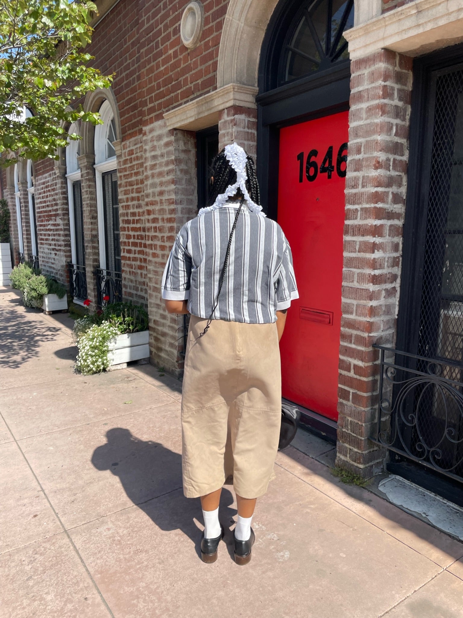 girl wearing black and white striped shirt and long tan skirt