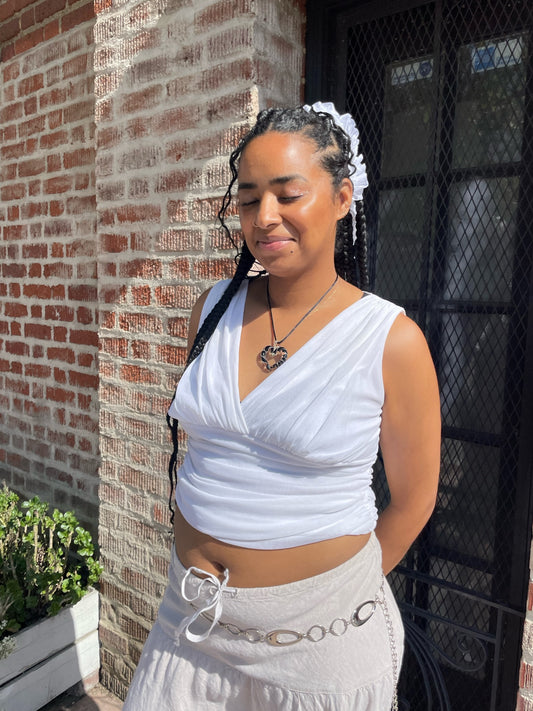 girl in white tank and tan skirt