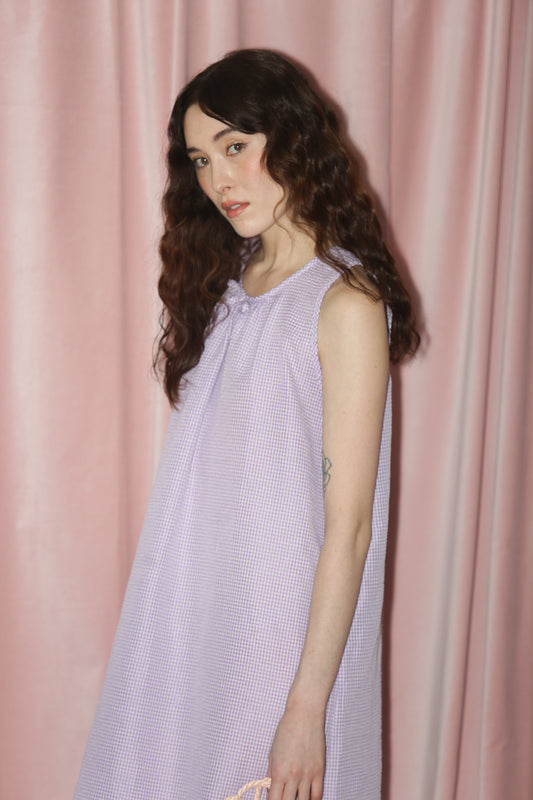 girl in purple gingham dress